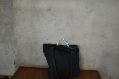 Close-up of chair on table against wall