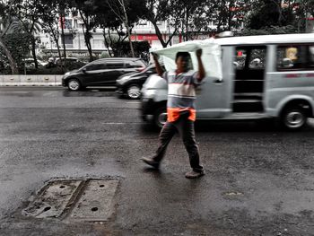 Woman on car in city