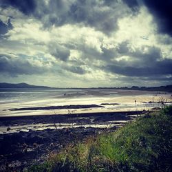 Scenic view of sea against storm clouds