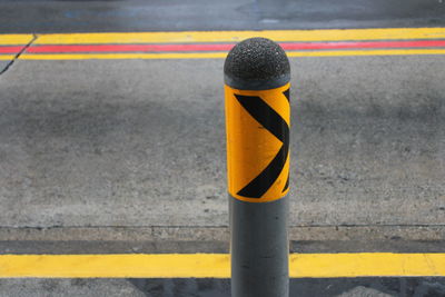 Close-up of yellow umbrella on road