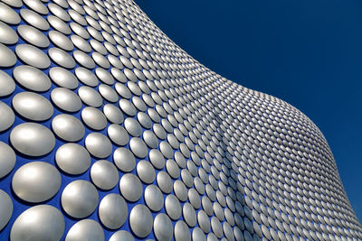 Low angle view of modern building against clear blue sky