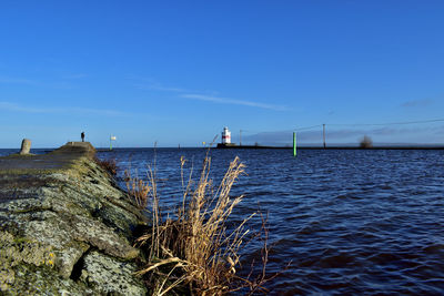 Scenic view of sea against blue sky