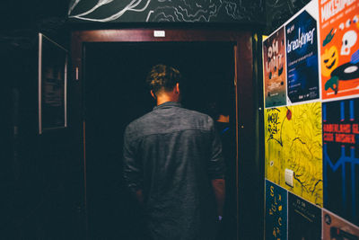 Rear view of man at doorway in nightclub