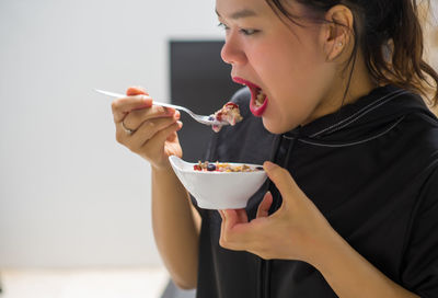 Midsection of woman eating food