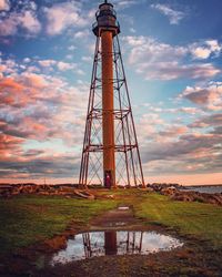 Low angle view of tower on field against sky