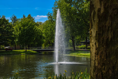 Water splashing in fountain against sky