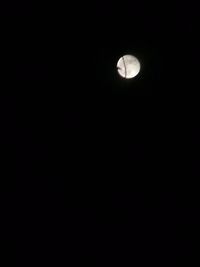 Low angle view of moon against sky at night