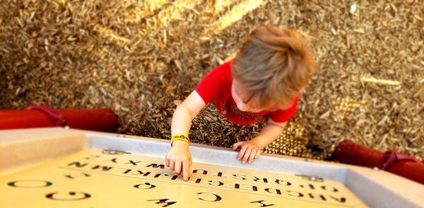 High angle view of boy playing in workshop