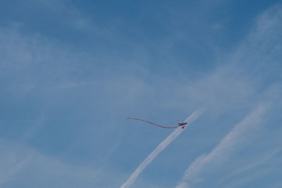 Low angle view of kite flying against blue sky