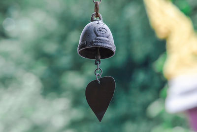 Close-up of heart shape hanging on metal