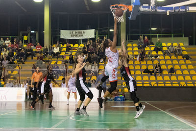 Group of people playing basketball court