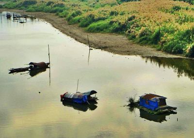 Boats moored in lake