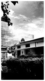 Buildings against cloudy sky