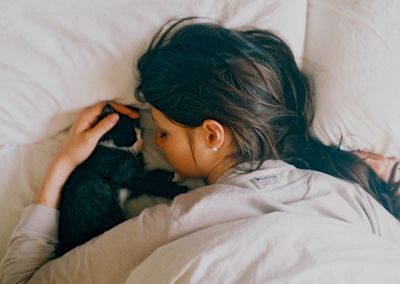 High angle view of woman sleeping on bed