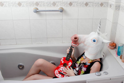 Close-up of baby lying down in bathroom