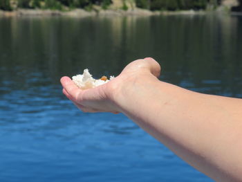 Midsection of man holding sea