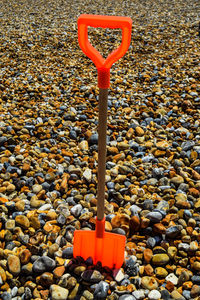 Close-up of red spade on beach