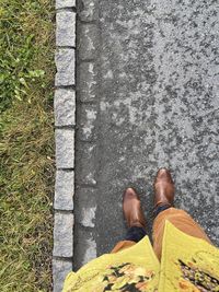 Low section of man standing on ground