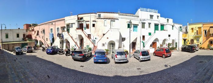 Panoramic view of street amidst buildings against sky