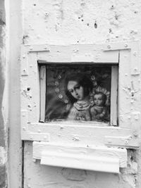 Portrait of woman looking through window