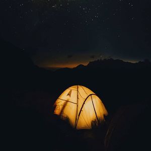 Scenic view of silhouette mountains against sky at night