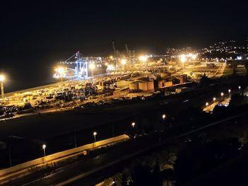 High angle view of illuminated city against sky at night