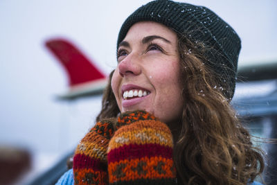 Woman surfer portrait with frozen surfboard