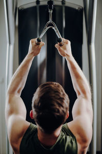 Rear view of woman exercising in gym