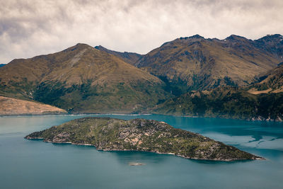 Scenic view of lake and mountains against sky