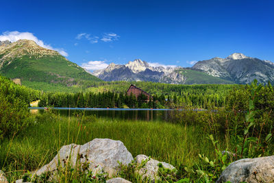 Scenic view of lake and mountains against sky