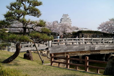 Built structure by trees against sky