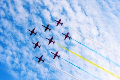 Low angle view of airshow against sky