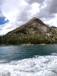 Scenic view of sea and mountains against sky