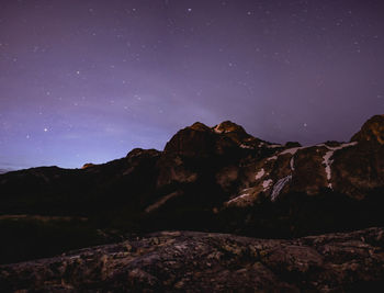 Low angle view of mountain against sky at night