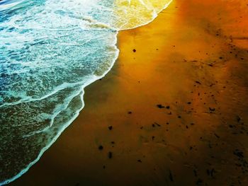 High angle view of waves reaching shore at beach