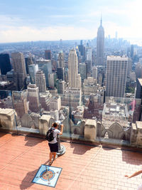 View of cityscape against cloudy sky