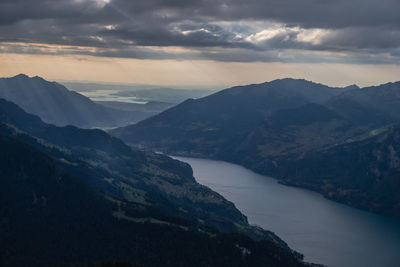 Scenic view of river and mountains against sky