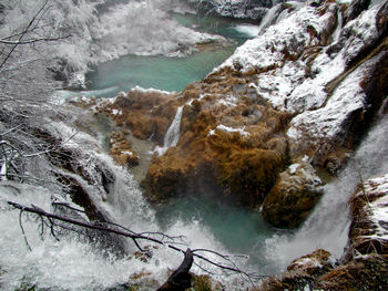 Scenic view of waterfall in forest, high angle, lake.