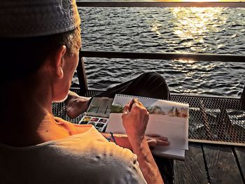 High angle view of mobile phone in sea