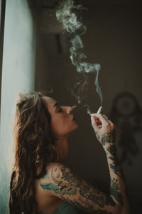 Young woman smoking cigarette