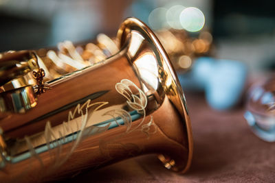 Close-up of alto saxophone on table