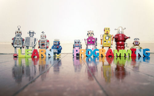 Multi colored toys on table against gray background