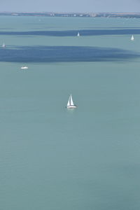 Sailboat sailing on sea against sky