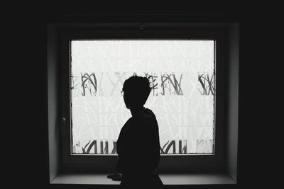 Woman looking through window