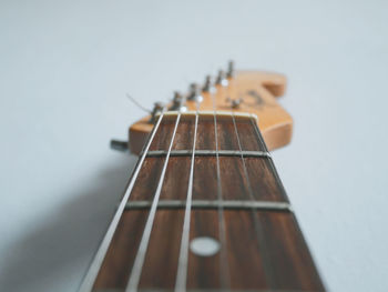 Close-up of guitar against white background