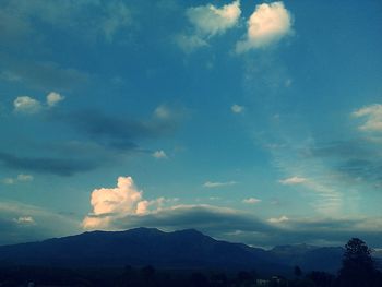 Scenic view of mountains against cloudy sky