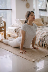 Woman practicing yoga at home