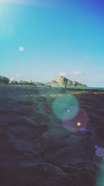 Scenic view of beach against clear blue sky