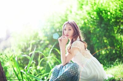 Portrait of young woman standing on grass