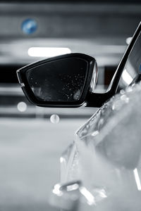 Close-up of reflection on side-view mirror of car